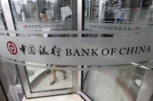 A woman leaves a branch of Bank of China in Beijing