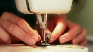stock-footage-woman-sewing-clothes